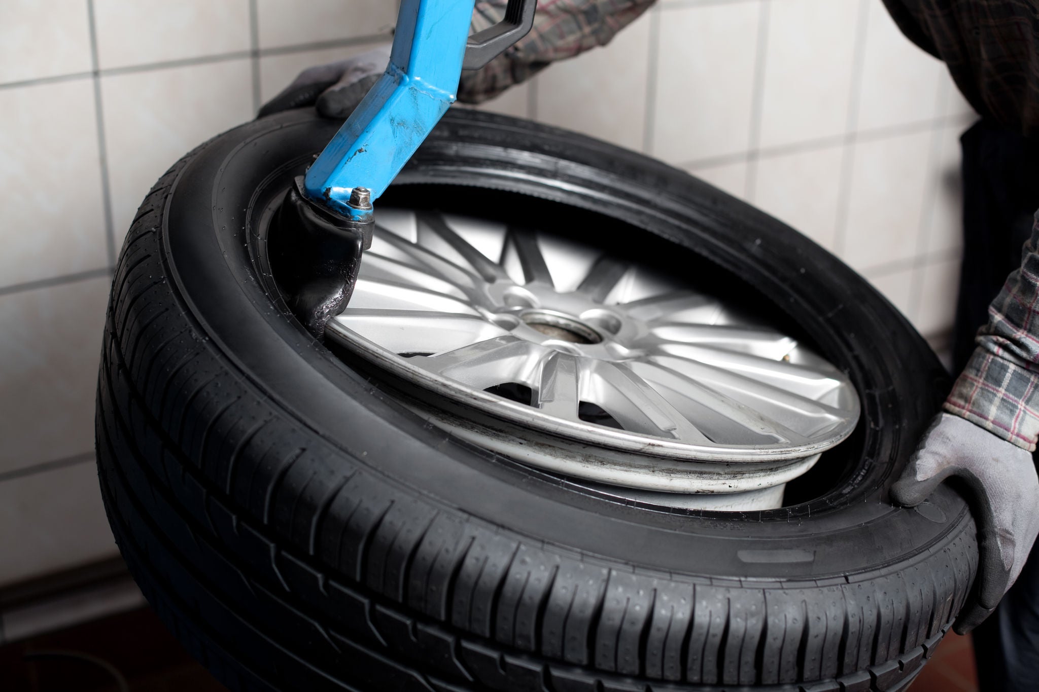 Mechanic changing  car tire closeup